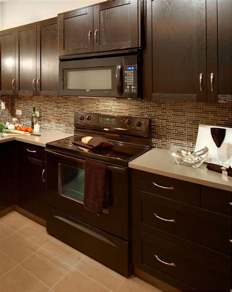 dark brown kitchen cabinets with stainless steel appliances|brown cabinet white countertop kitchen.